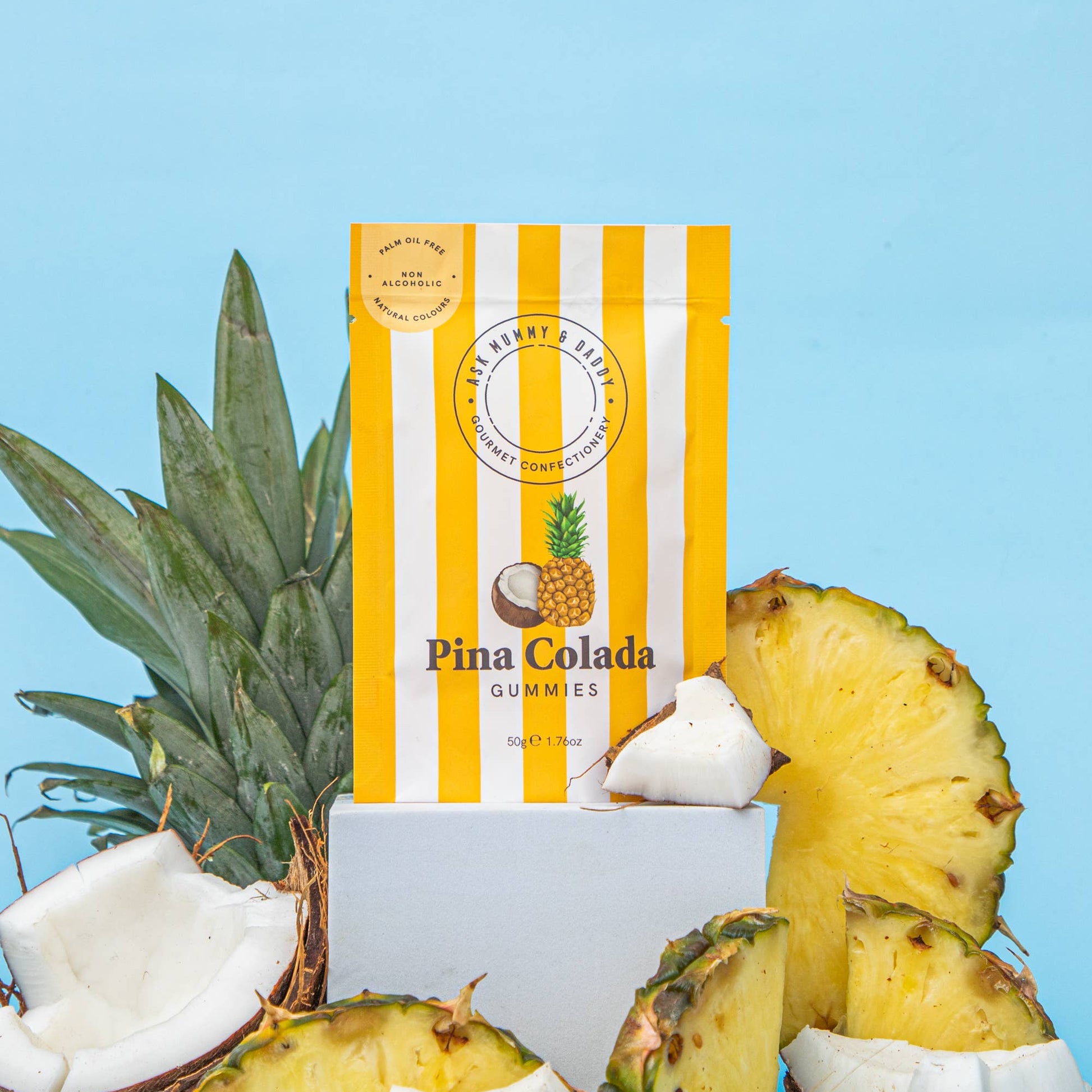 Pina Colada gummies pouch with pineapple slices and coconut on blue