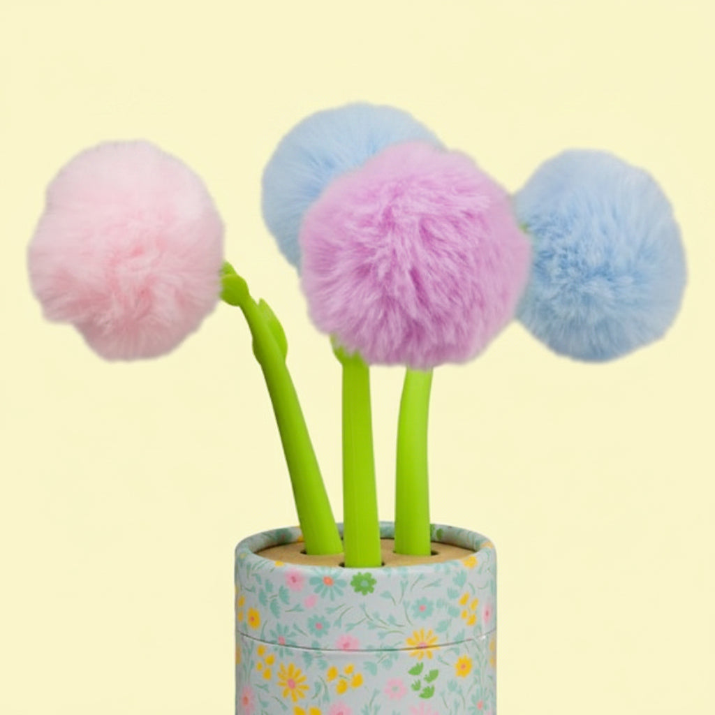Three colorful pom-pom pens in a holder with a floral design on a white background