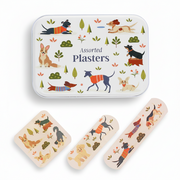 A tin of Assorted Plasters with three bandages displayed below, all decorated with a whimsical pattern of different dog breeds in colorful sweaters, trees, and flowers on a white background.