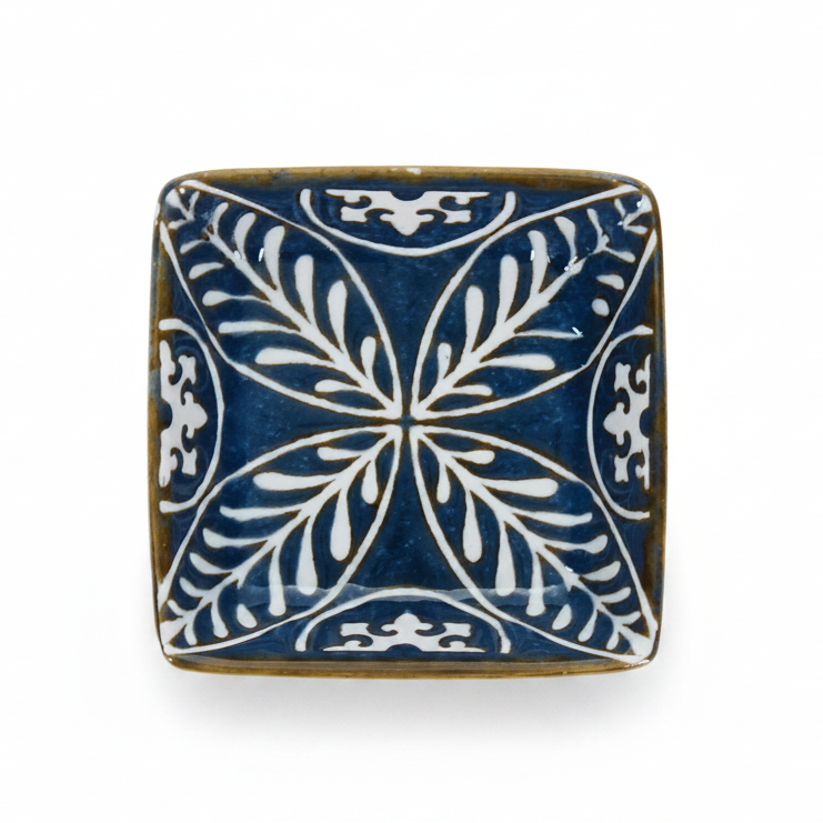 Blue square ceramic dipping bowl, side angle on white background.