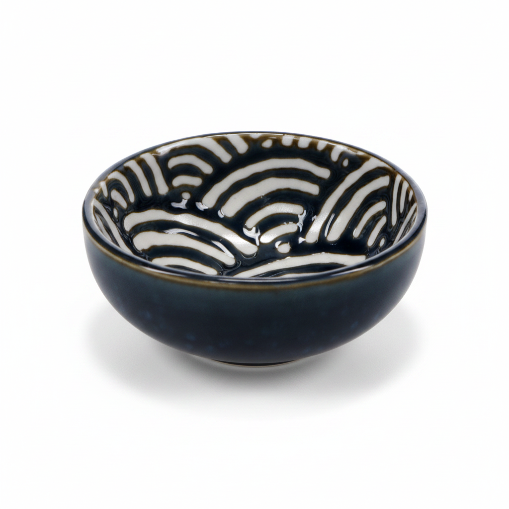 A small ceramic bowl with a glossy dark navy blue exterior and a white interior decorated with a black zebra-like wavy pattern, set against a plain white background.