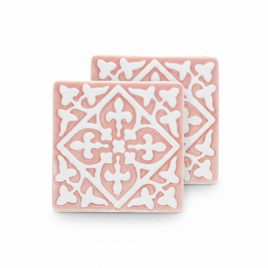 Pink ceramic tile coasters with white embossed pattern, set of two.