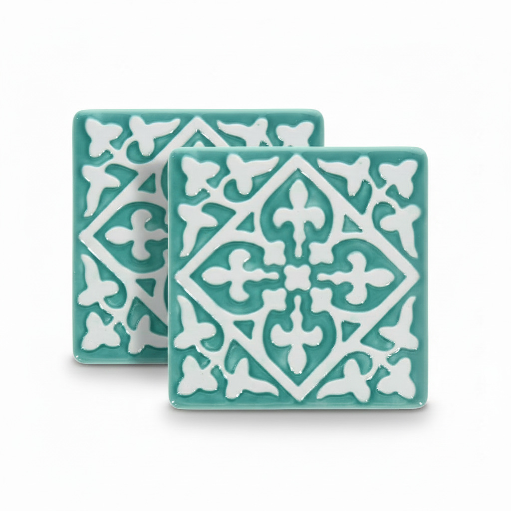 Turquoise ceramic tile coasters with white embossed pattern, set of two.