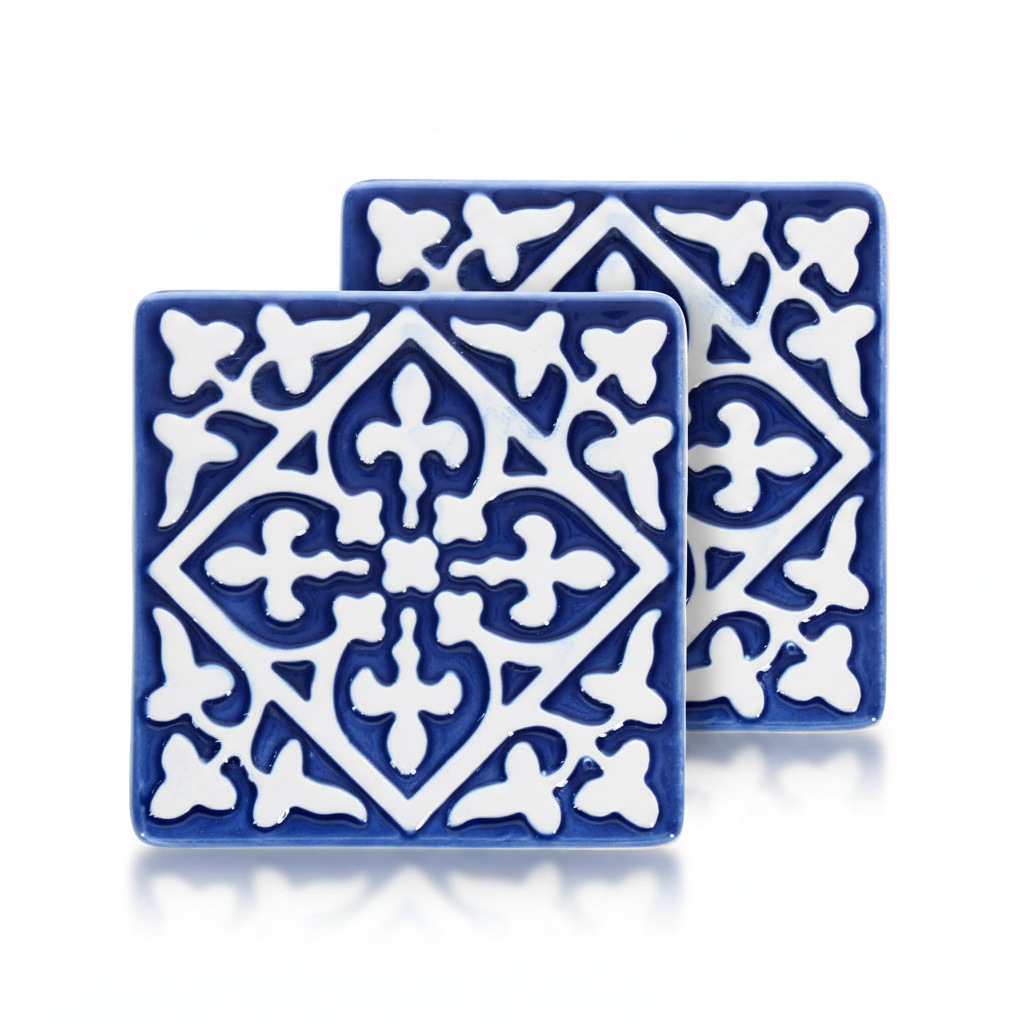 Navy ceramic tile coasters with white embossed pattern, set of two.