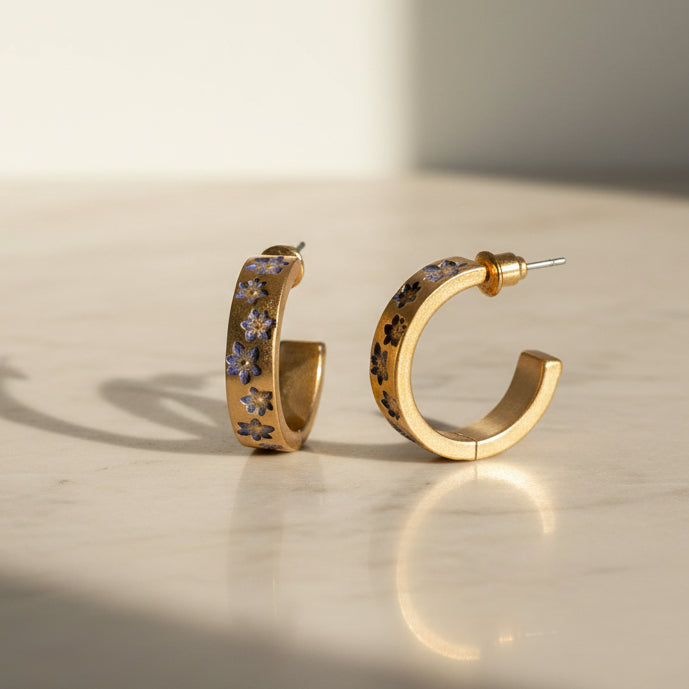 Nightshade gold hoop earrings with blue and purple enamel flowers - front view