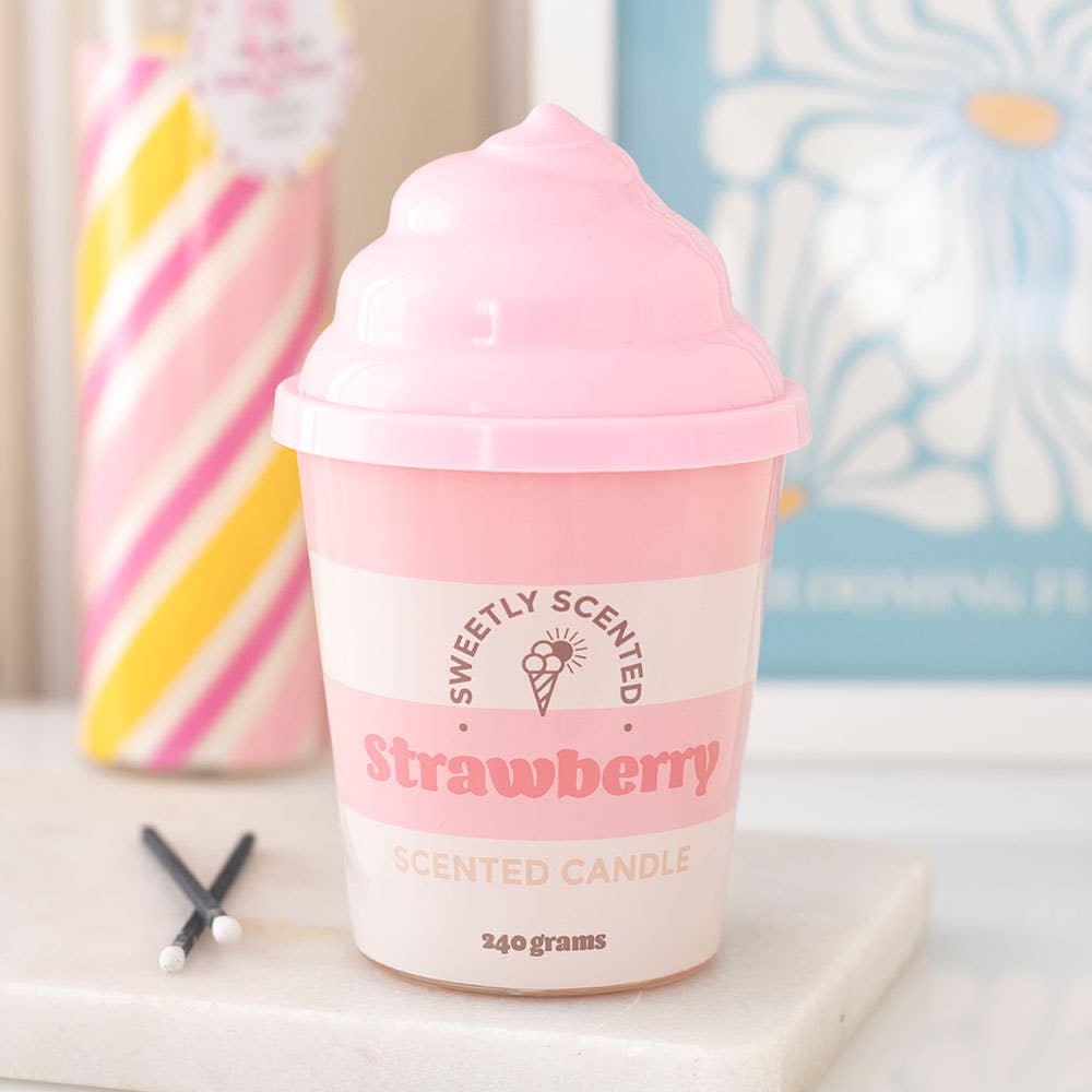 Strawberry ice cream scented candle styled on marble with candy cane