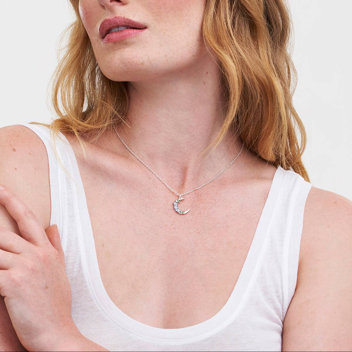 Nightshade Moon necklace worn around a model's neck