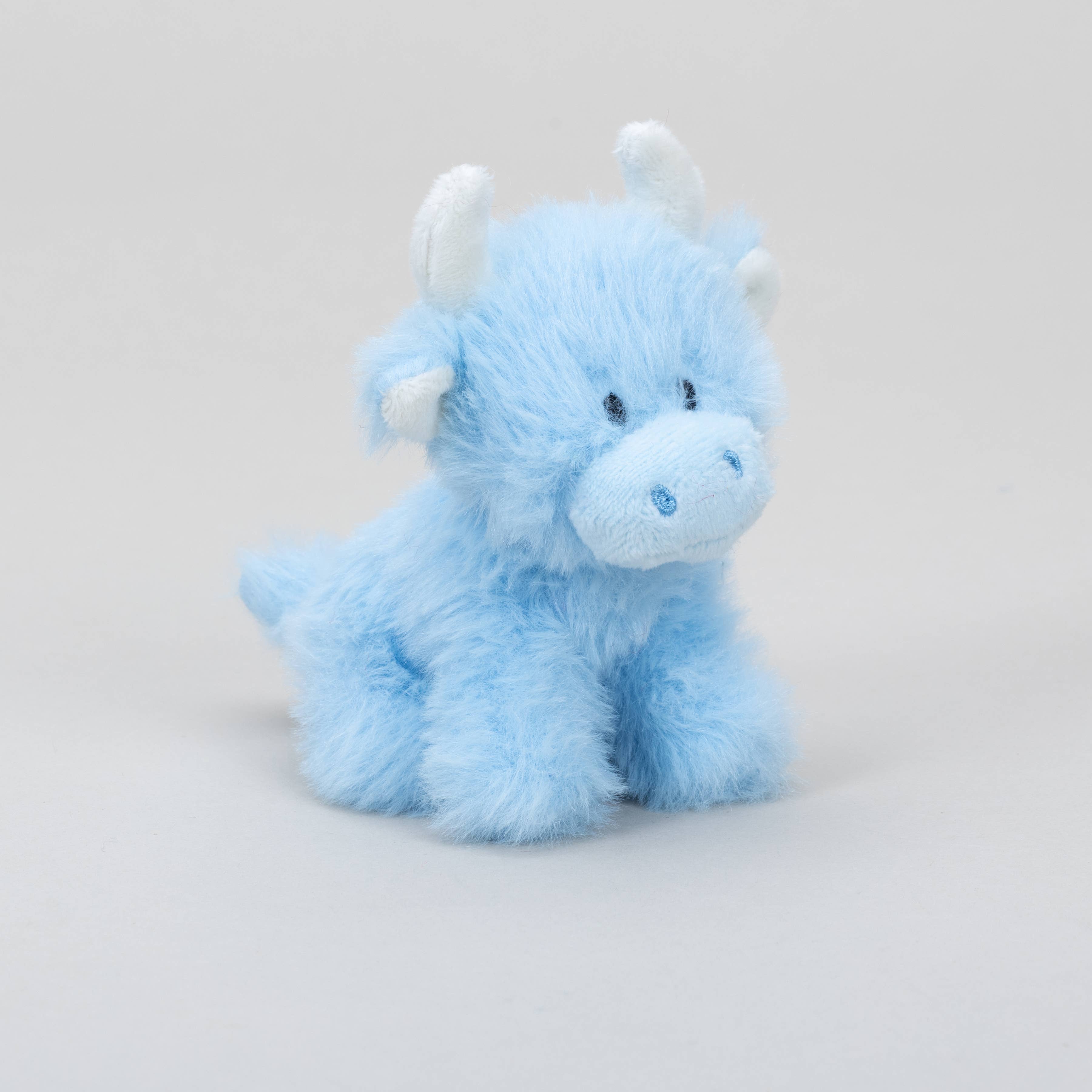 Baby blue mini highland cow plush angled view on grey