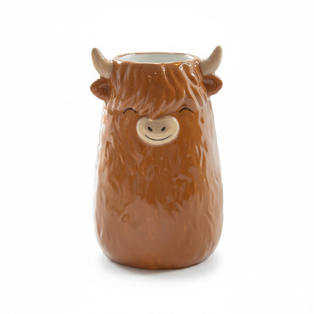 Brown ceramic Highland Cow small vase with horns and fluffy fringe on white background