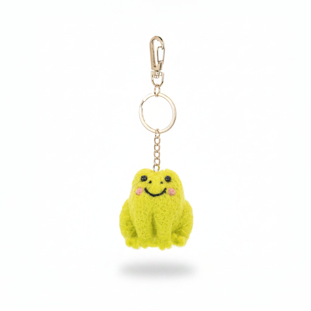 Handcrafted frog keyring showing soft felt body and detailed stitching