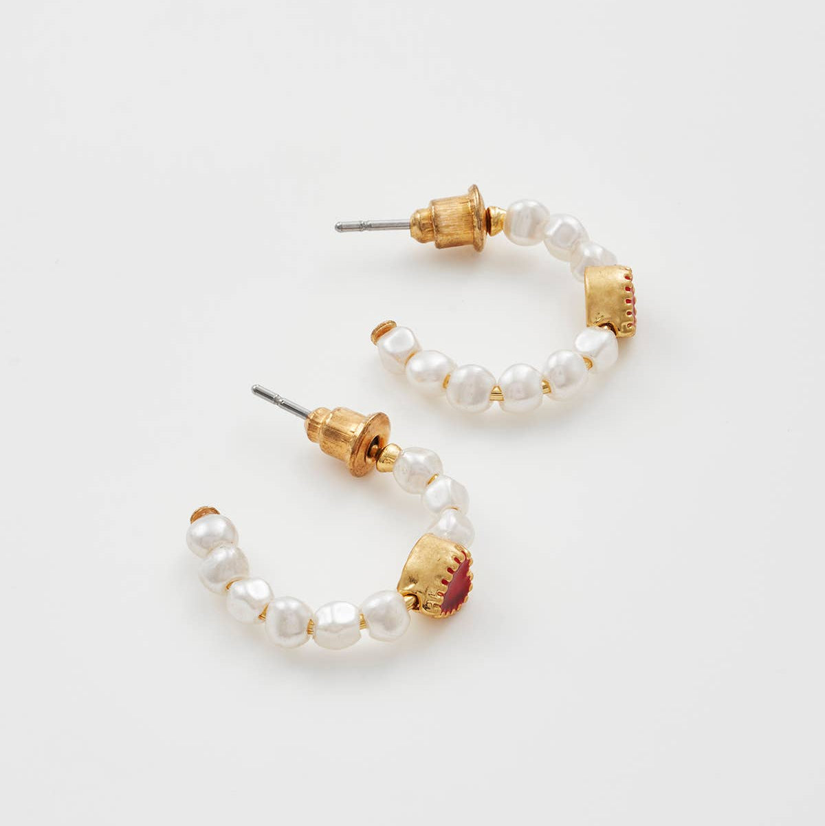 Pair of heart pearl hoops shown side by side