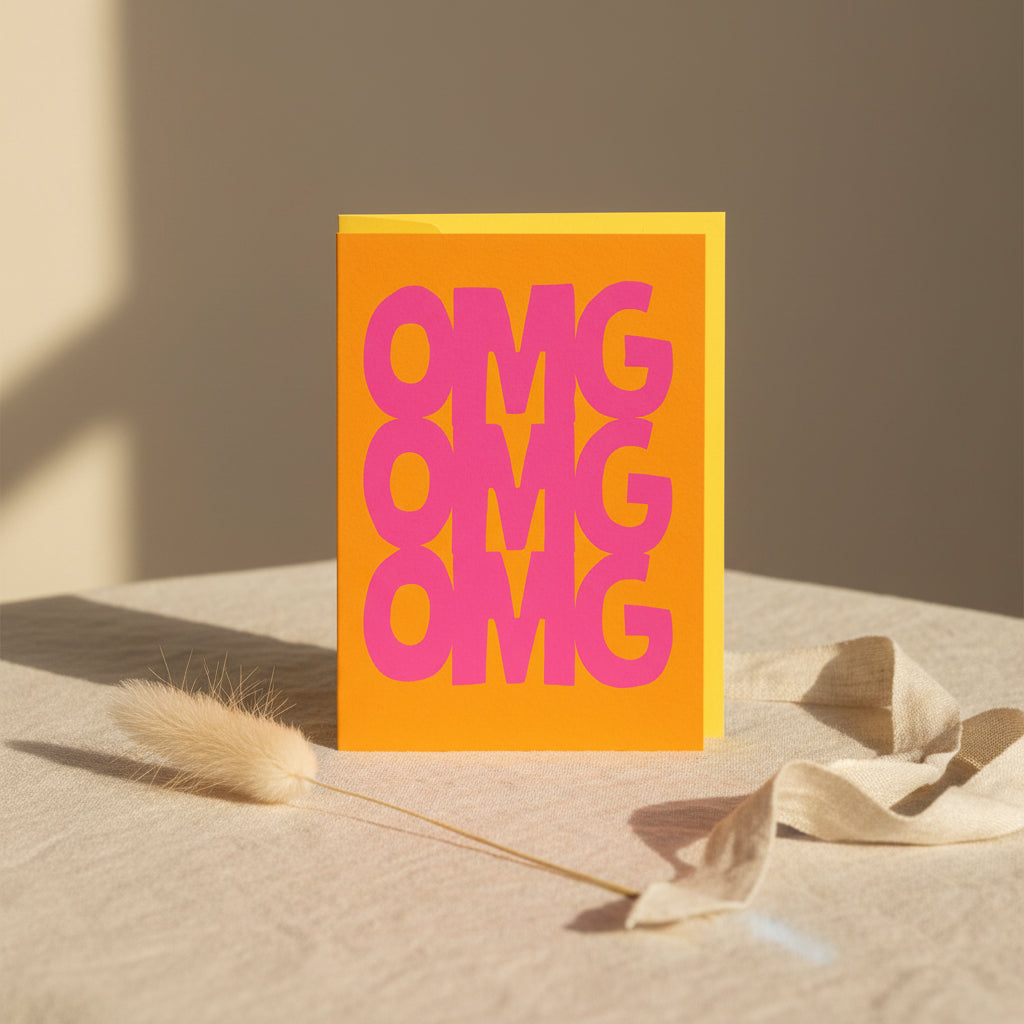 Card with 'OMG' text in pink on an orange background