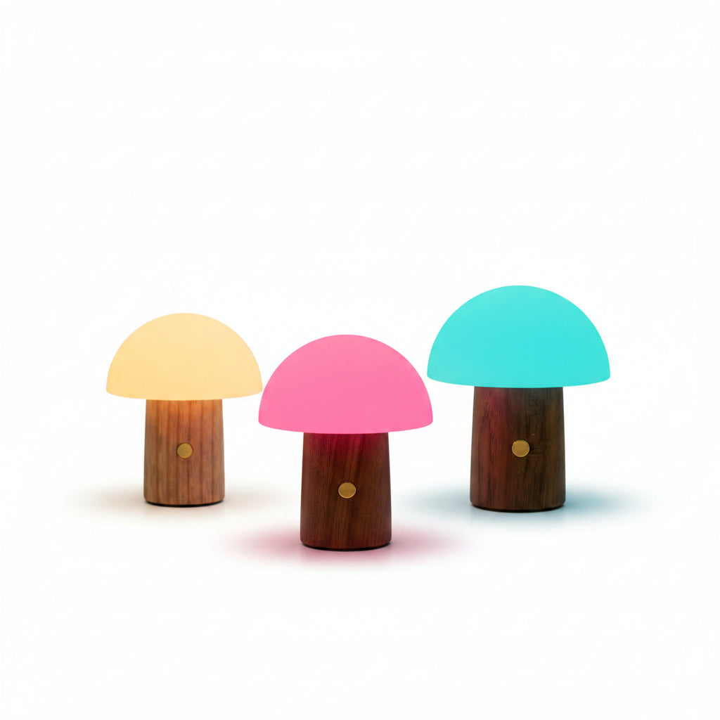 Alice Mushroom Lamp Super Mini glowing in yellow, pink, and blue on a wooden desk.