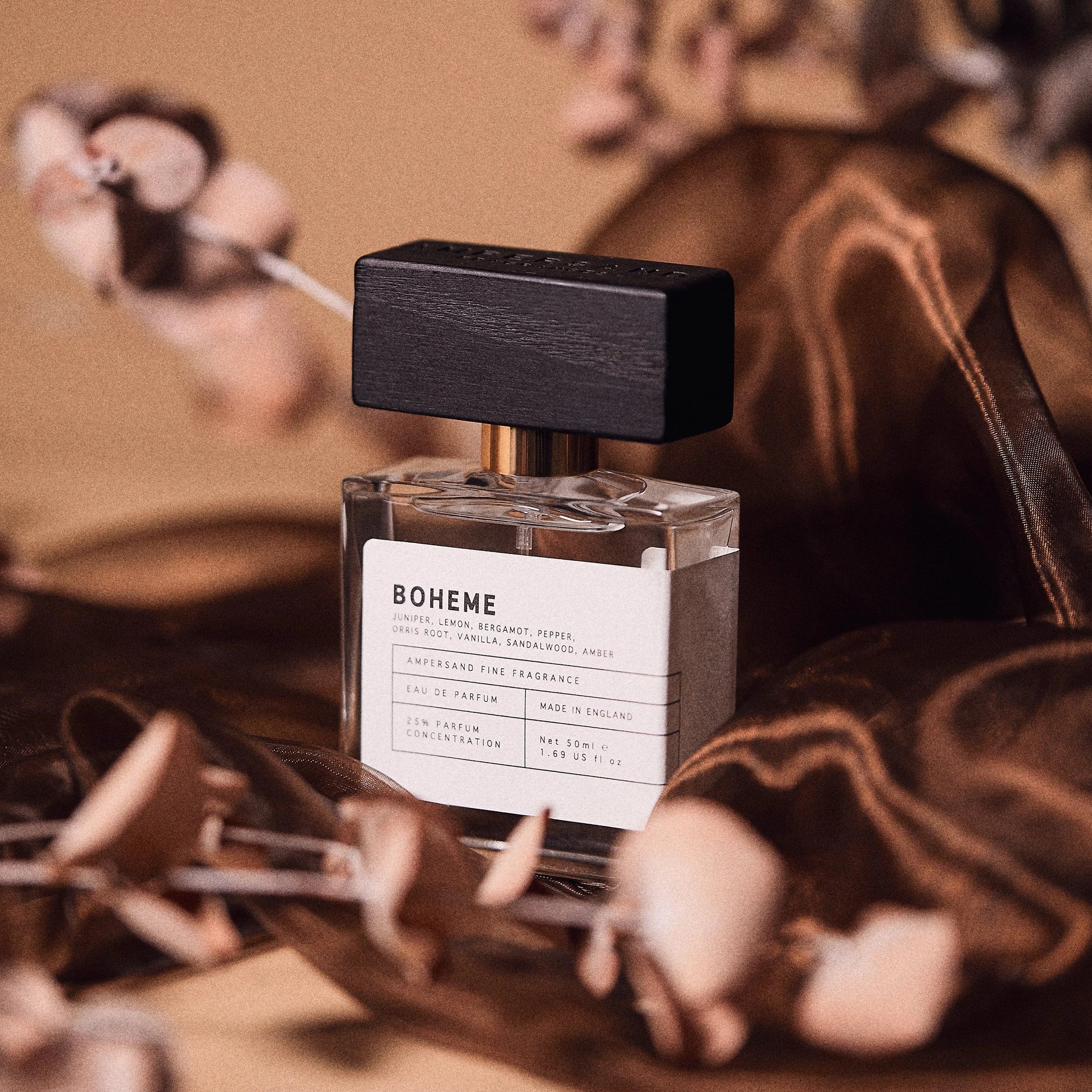 Boheme fragrance bottle with dried flowers on warm surface