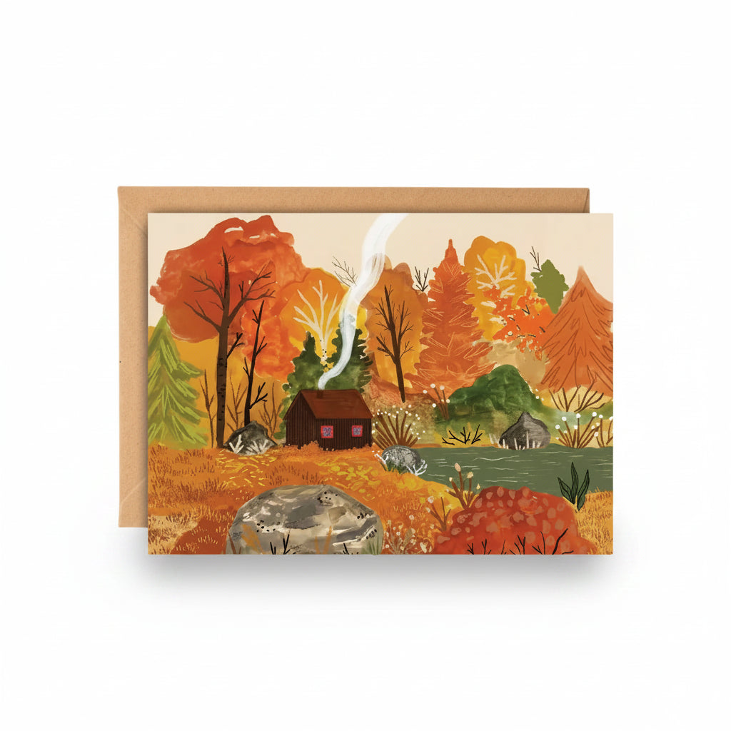 Autumn Cabin greeting card by Charis Raine with a cosy cabin in autumn woodland and kraft envelope