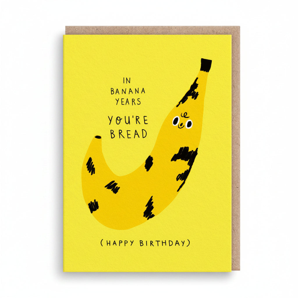 Bright yellow birthday card with a bruised smiling banana illustration