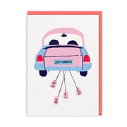 White wedding card with illustrated getaway car trailing tin cans behind