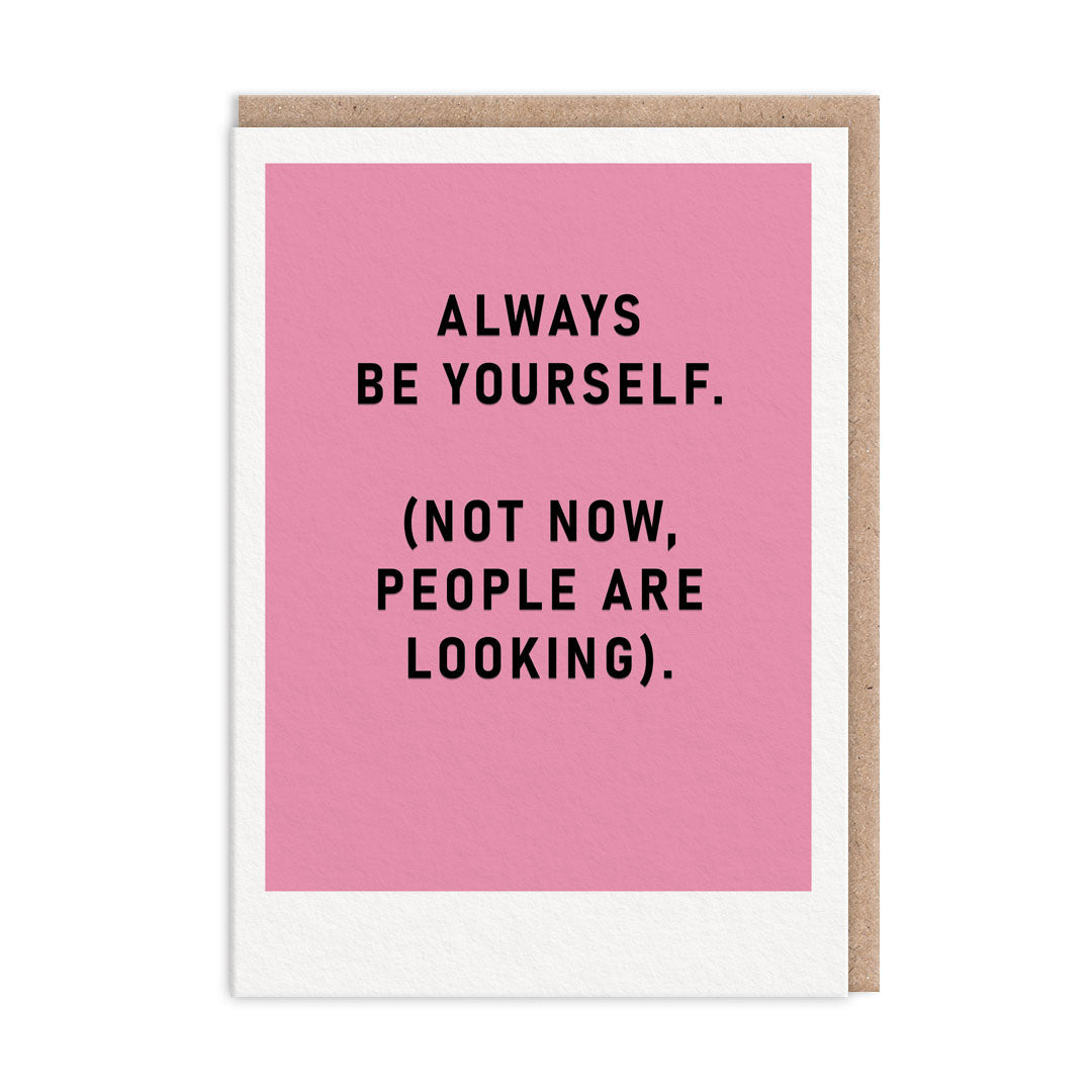 Pink greeting card reading Always Be Yourself with a joking bracketed line