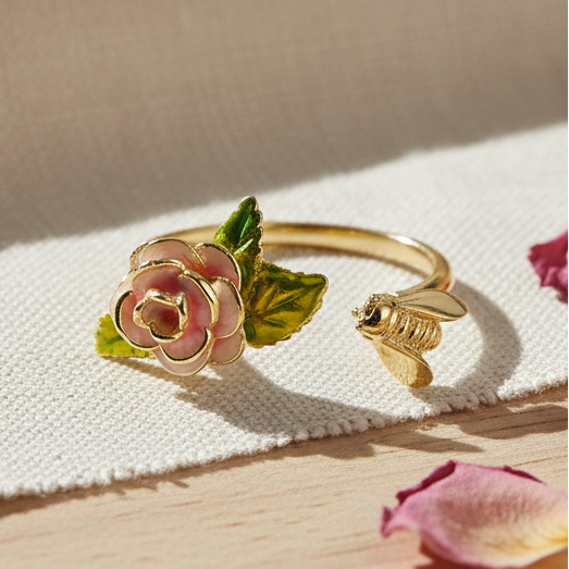 Vintage rose and bee ring on white linen with scattered pink petals