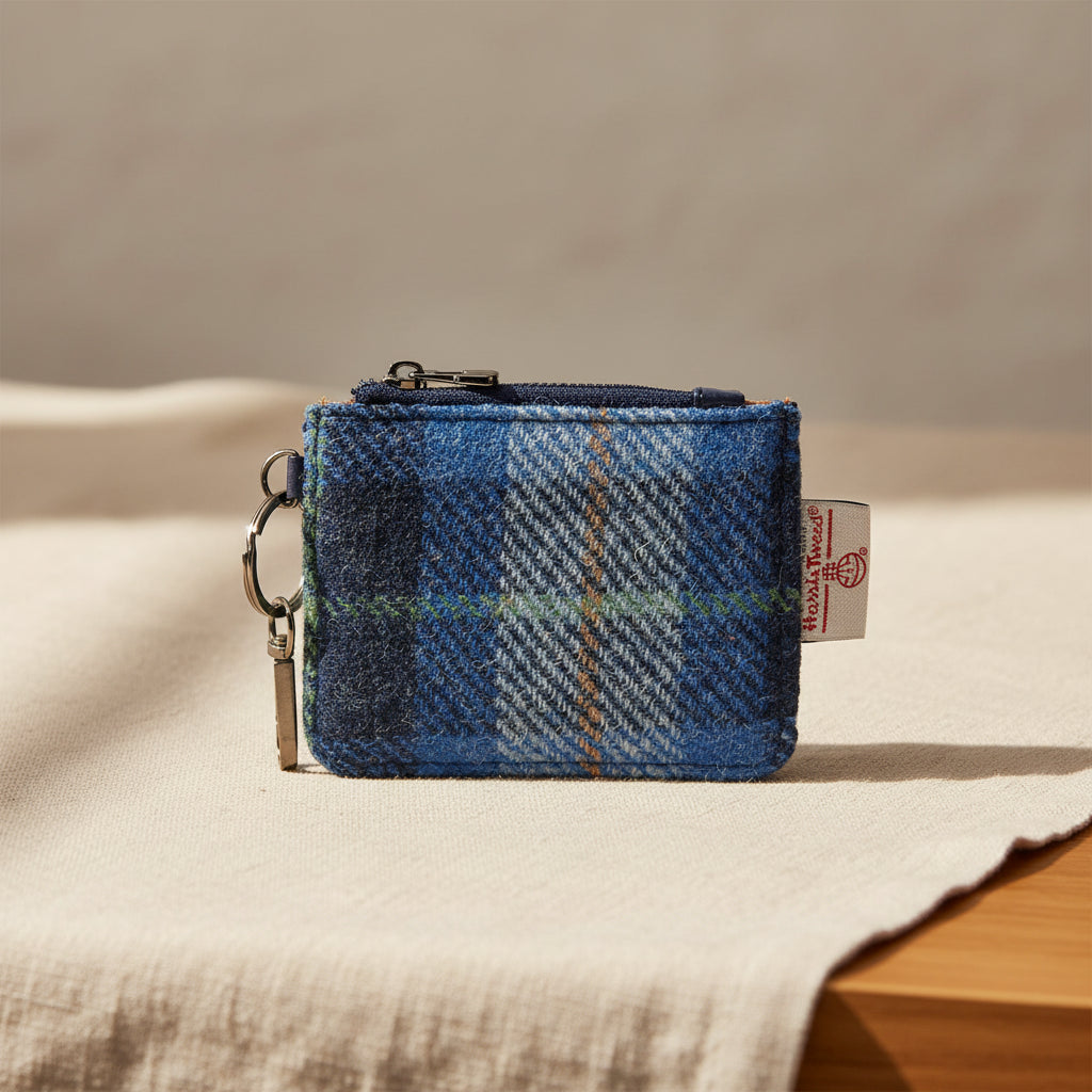 Blue plaid coin purse with a keychain on a white background