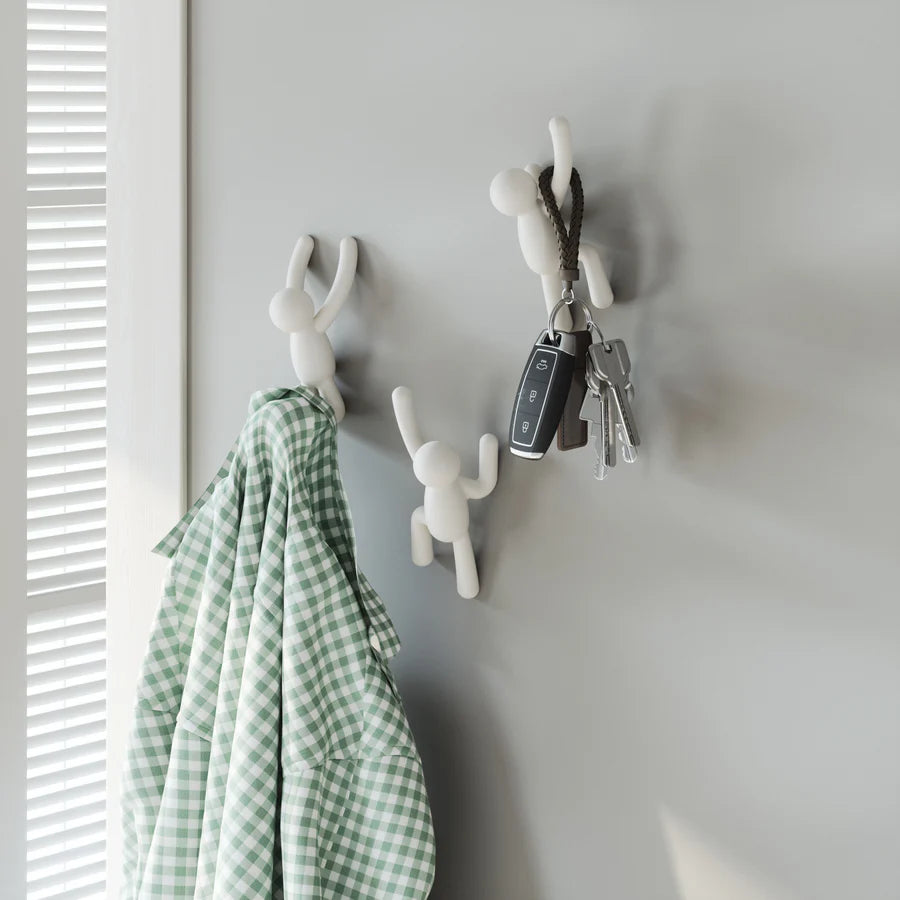 Umbra Buddy wall hooks set of three in white mounted on wall with items
