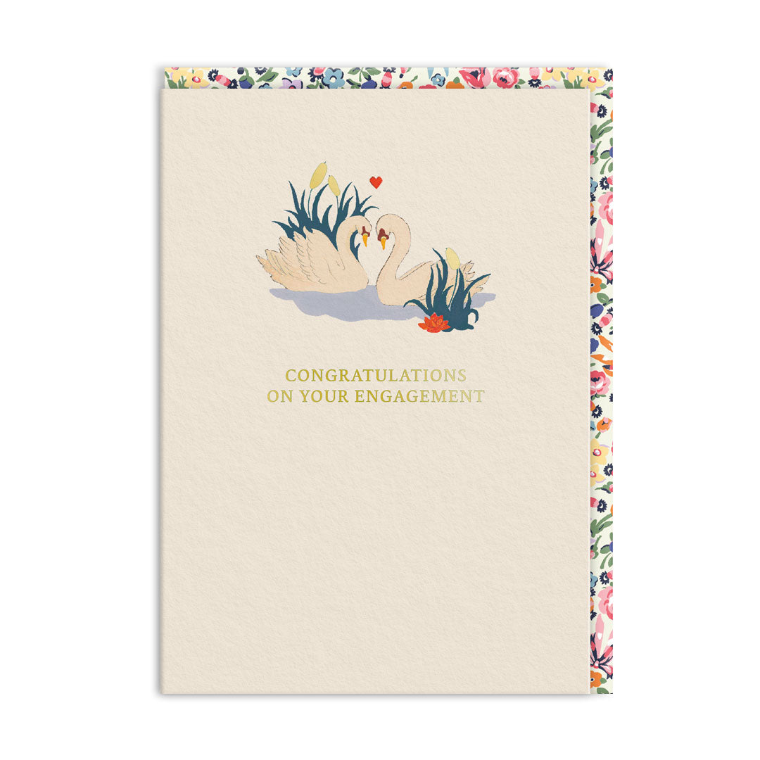Cream engagement card with two swans facing each other beside a water lily