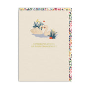 Cream engagement card with two swans facing each other beside a water lily