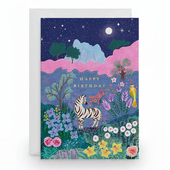 Navy birthday card with a zebra in a moonlit flowering meadow