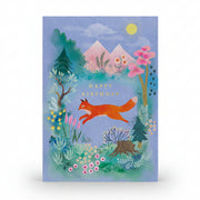 Blue birthday card with an orange fox leaping across a mountain meadow