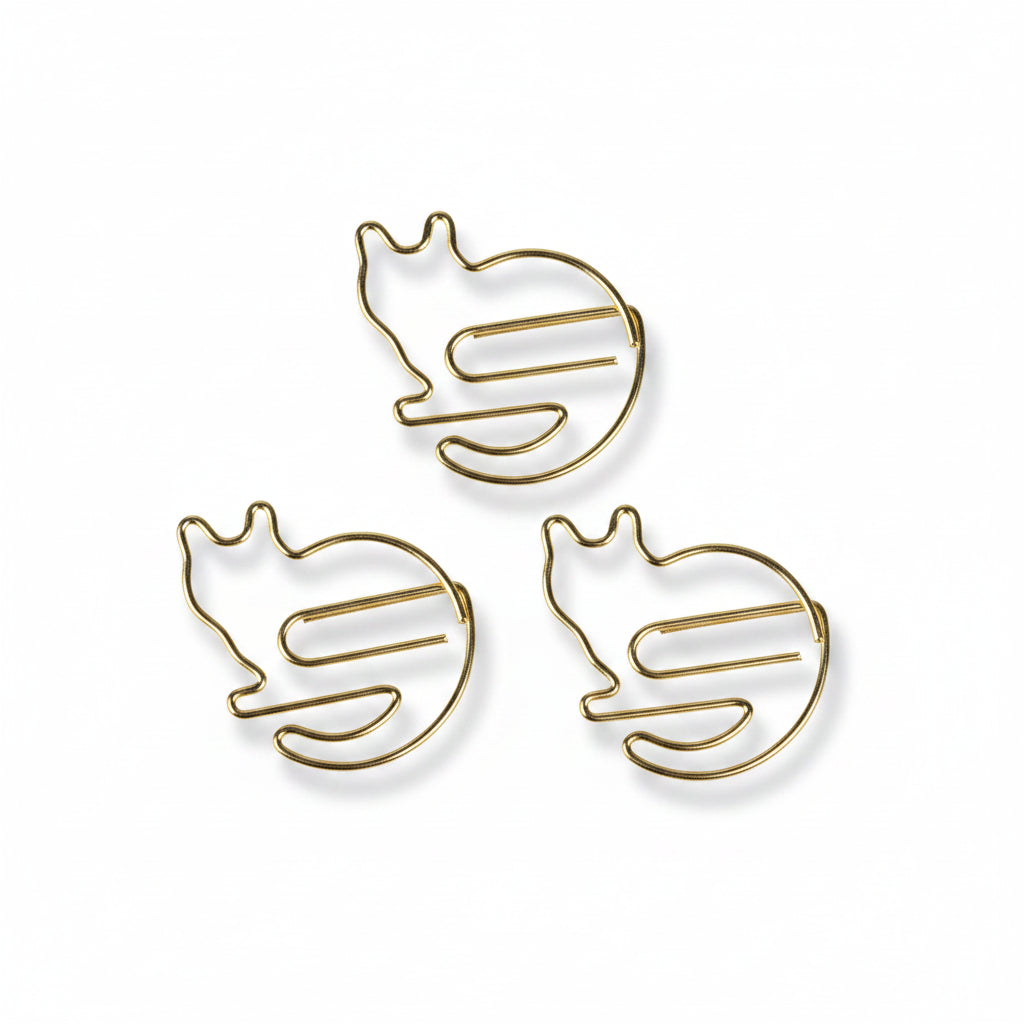 Set of 5 gold cat-shaped paper clips arranged on white background.