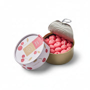 Open cherry-scented candle tin showing realistic cherry-shaped wax candles with pull-tab lid and illustrated packaging.