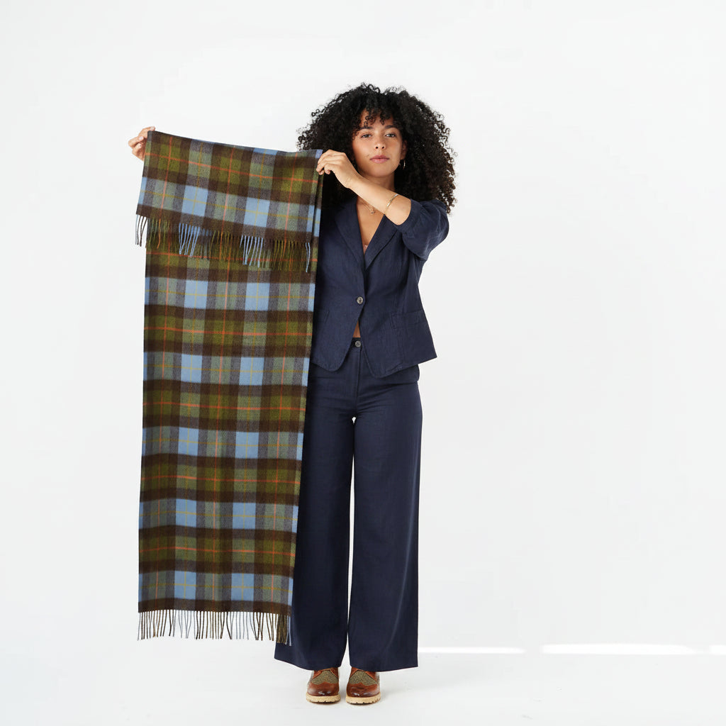 Model holding chestnut and blue tartan lambswool scarf to show size.
