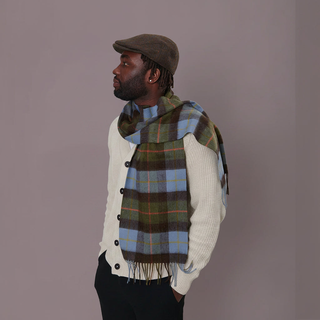 Man wearing chestnut and blue tartan lambswool scarf styled with coat.