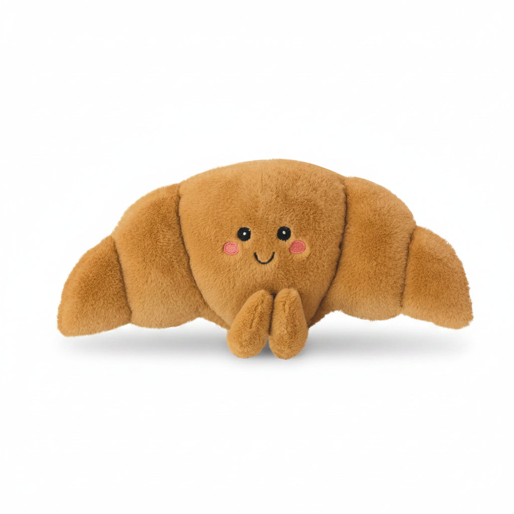 Plush Christoph Croissant Microwavable Hottie with smiling embroidered face and soft brown croissant design.