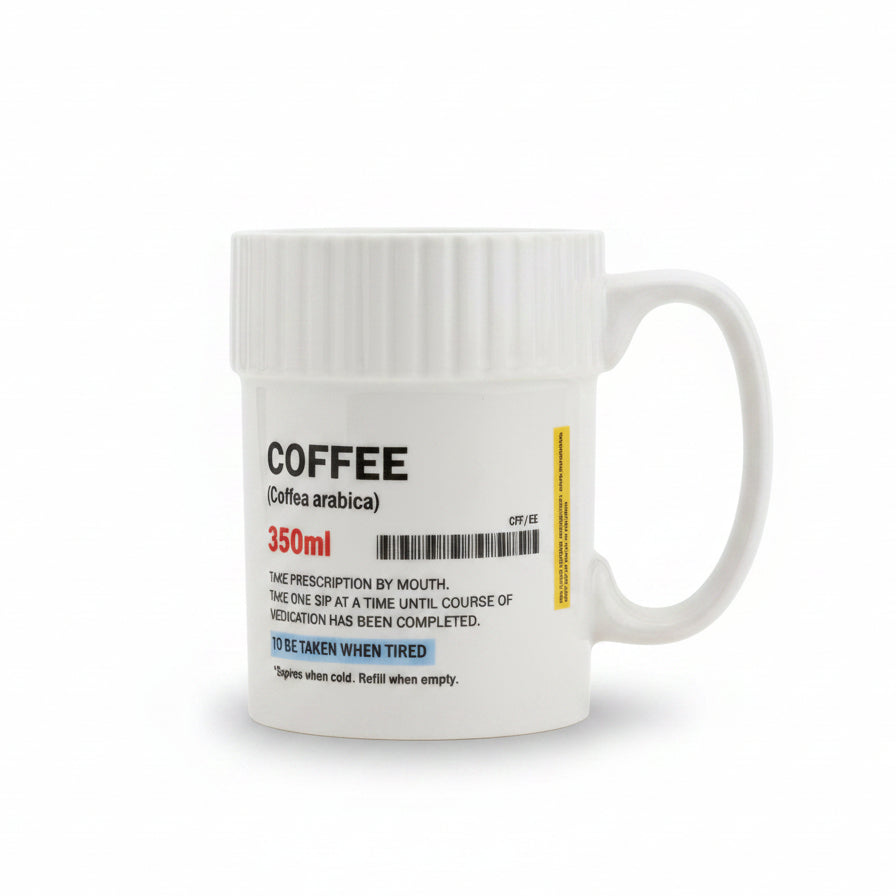 Coffee Pill Mug shaped like a prescription pill pot on a desk.