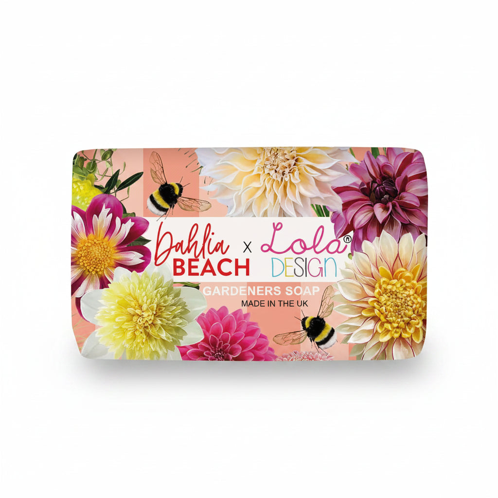 Dahlia Beach x Lola Design Gardeners Soap Bar featuring vibrant dahlia flowers and bees on pink packaging with shea butter, pink grapefruit and peach fragrance.