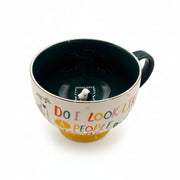 Overhead view showing hidden ceramic dog inside mug.