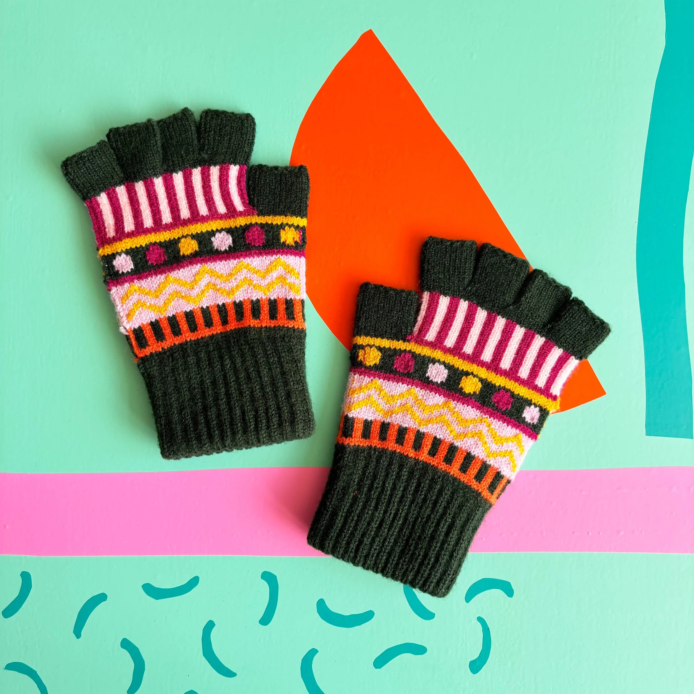Flat lay of patterned fingerless gloves showing Fair Isle detailing.