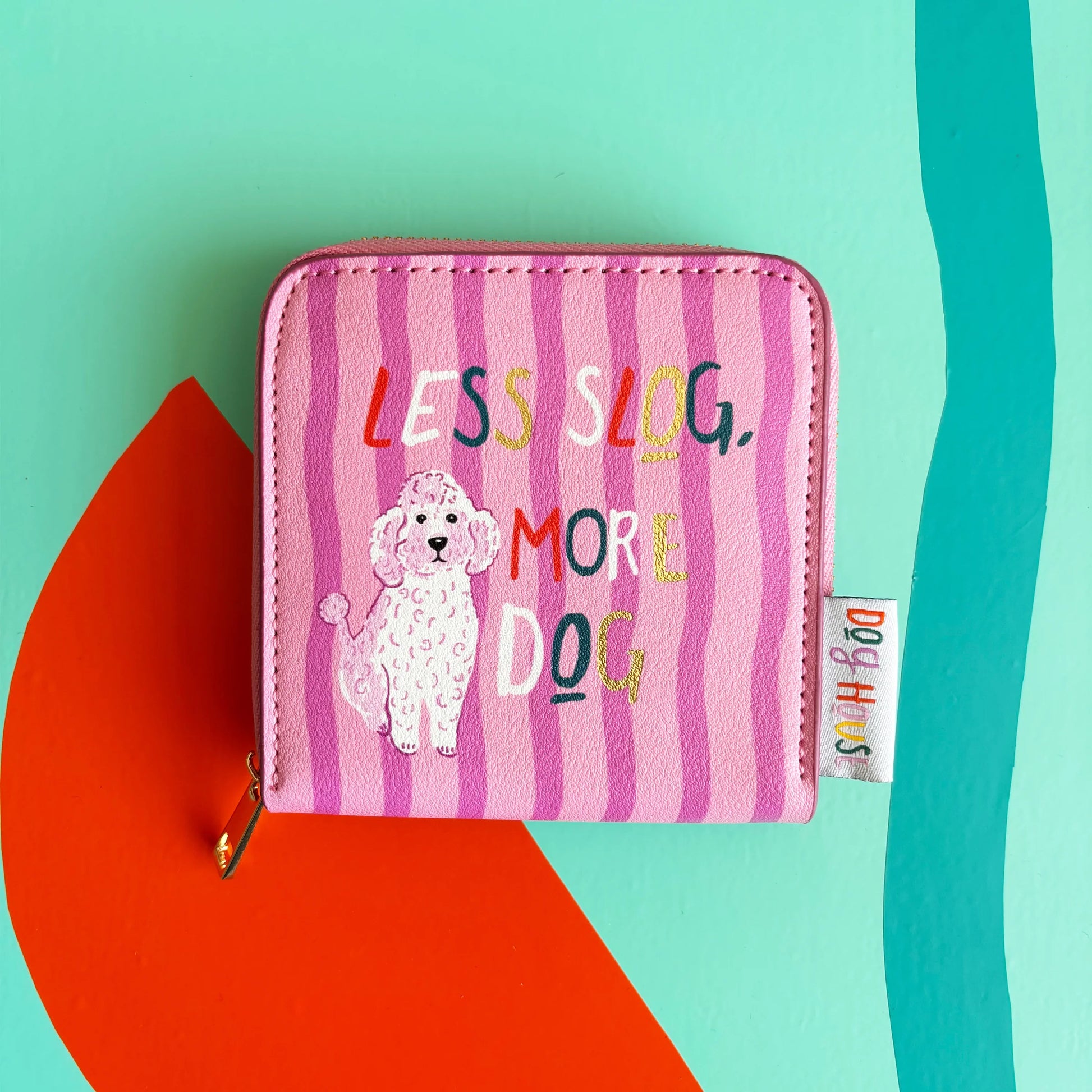 Close-up of pink striped Dog House Purse with illustrated poodle and colourful text.
