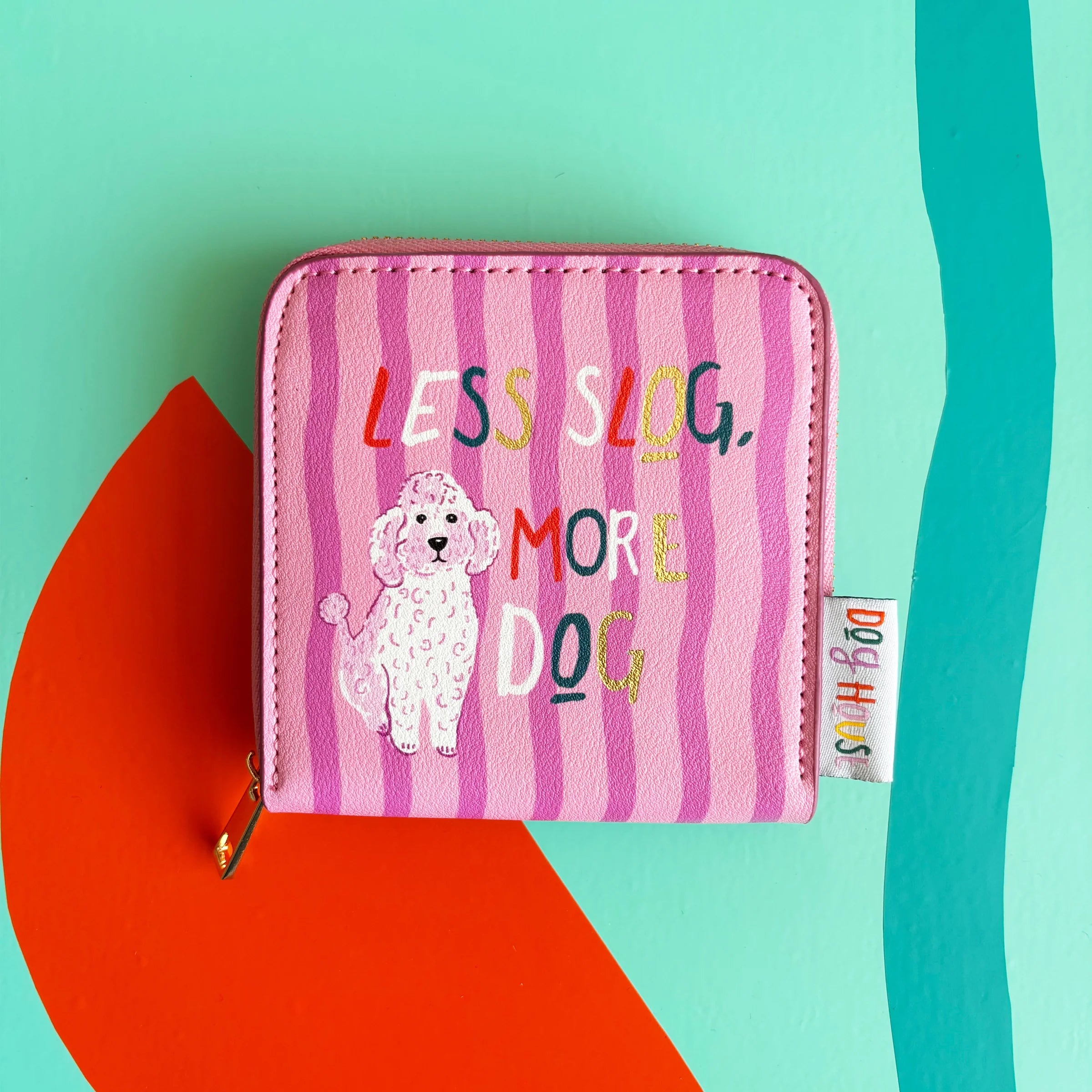 Close-up of pink striped Dog House Purse with illustrated poodle and colourful text.