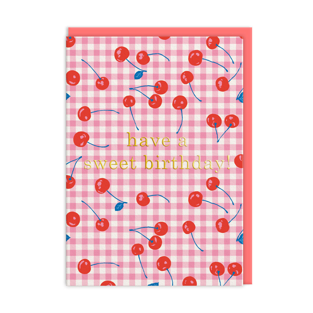 Pink gingham birthday card scattered with red cherries and gold foil text