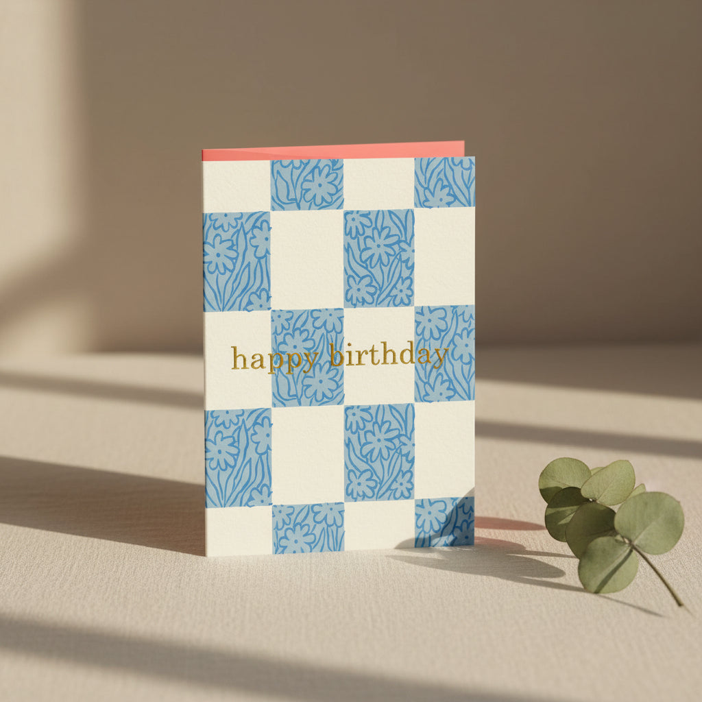 Birthday card with blue floral patterns and 'happy birthday' text on a white background
