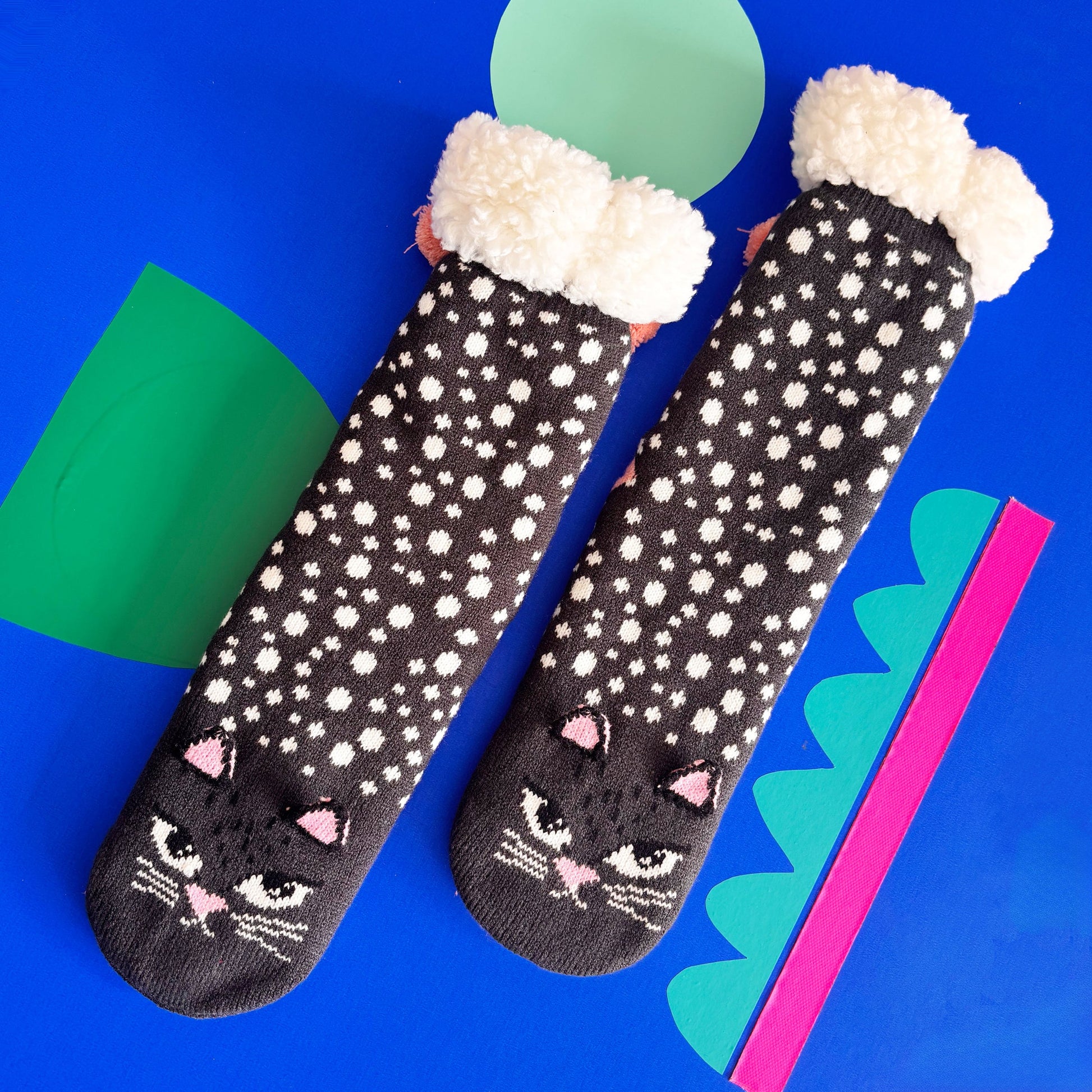 Pair of cat face slipper socks featuring 3D ears and pom poms.
