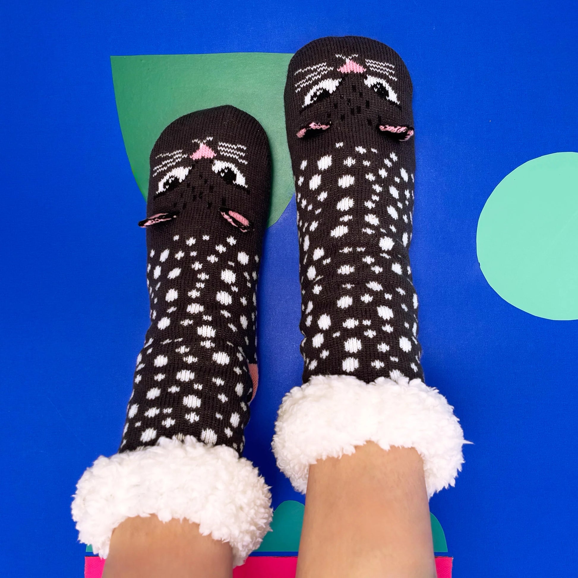 Overhead view of fluffy-lined socks with cat face detail.