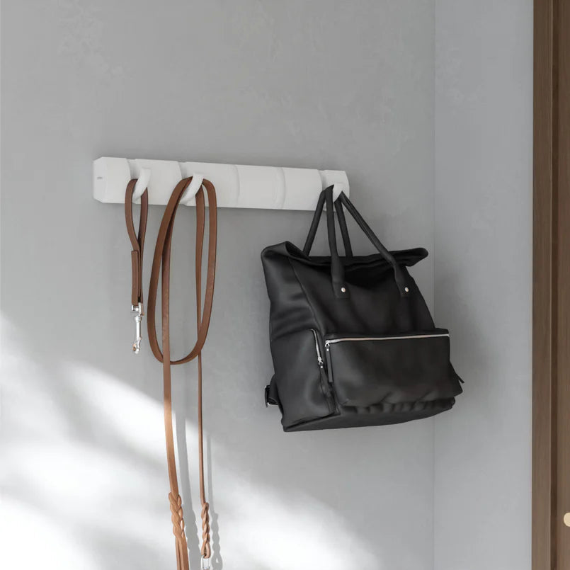 Umbra Flip 5 wall hook in white with bag and scarf hanging on grey wall