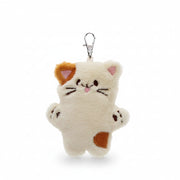 Cute plush cat bag charm showing embroidered whiskers and patch details.