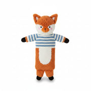 Fox Hot Water Bottle with striped jumper lying on sheepskin rug beside a cup of tea.