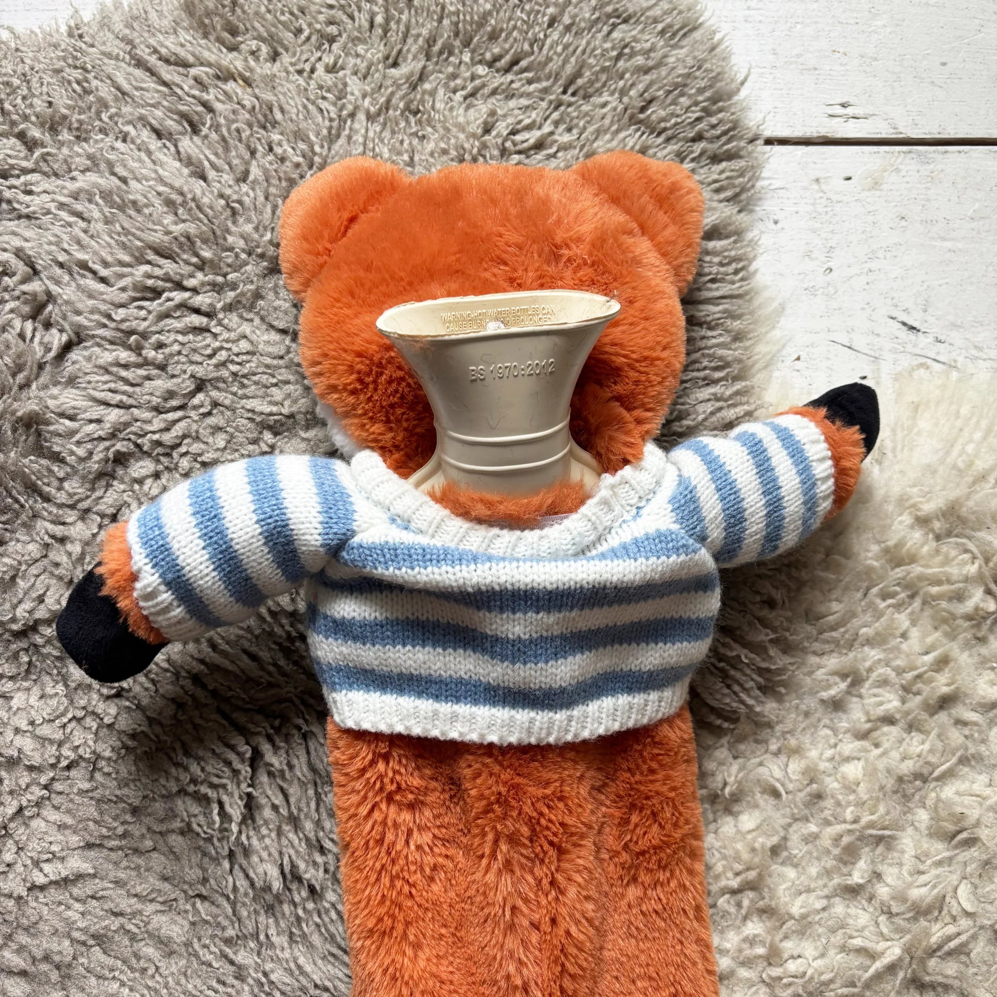 Back view revealing rubber bottle opening inside fox cover.