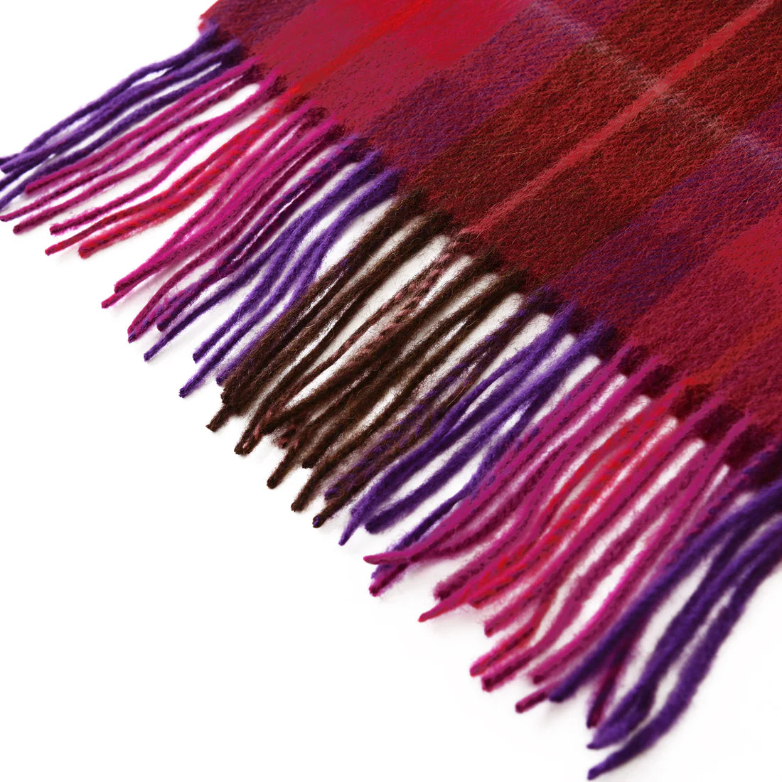 Close-up of fuchsia red tartan lambswool scarf fringed tassels in red, purple, and brown.
