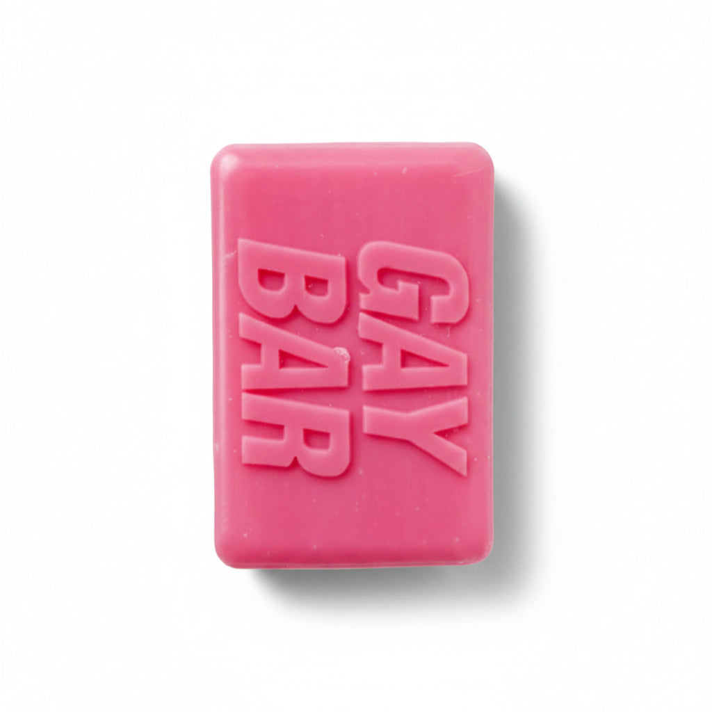 Hot-pink novelty soap bar embossed “GAY BAR” on white background – rose-scented LGBTQ+ gift from Contempo.